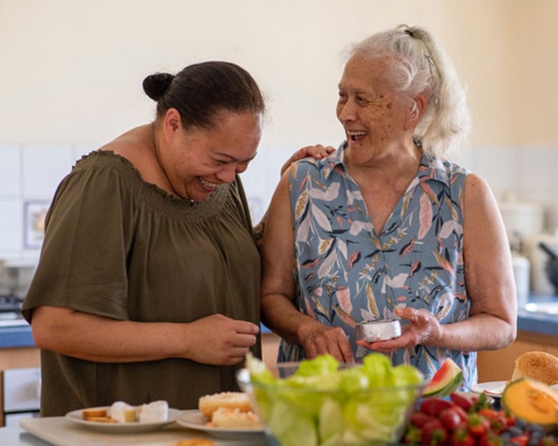Two women preparing a meal together