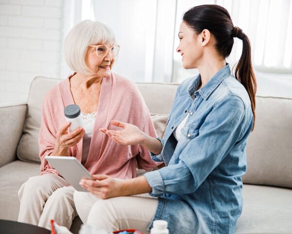 Caregiver handing client medication