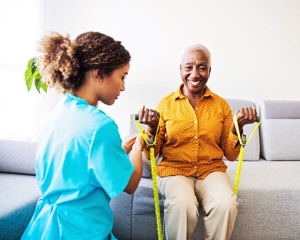 Caregiver helping client with physical therapy